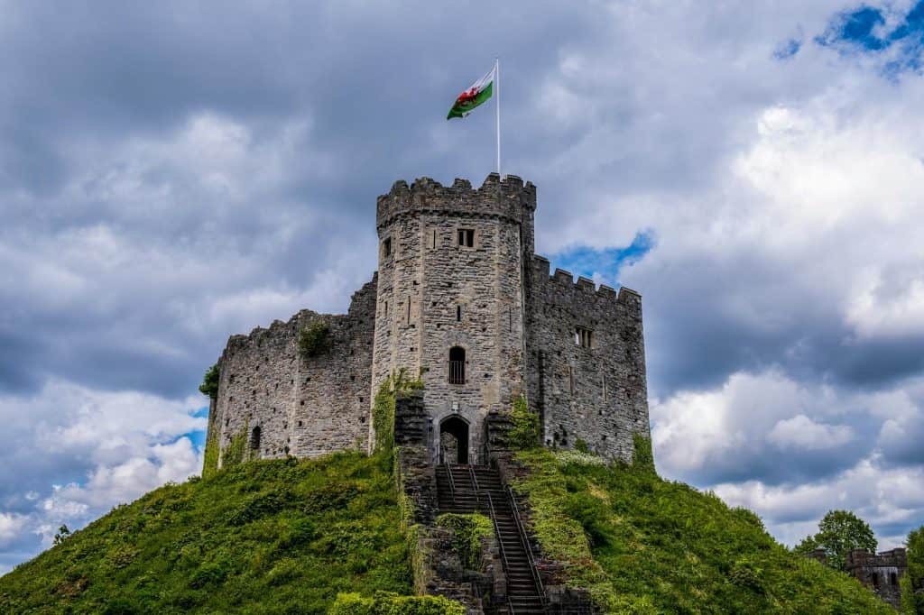 International students walking through Bute Park with Cardiff Castle nearby